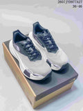 Pair of white and navy The North Face Summit Vectiv Pro trail running shoes displayed on a shoebox.