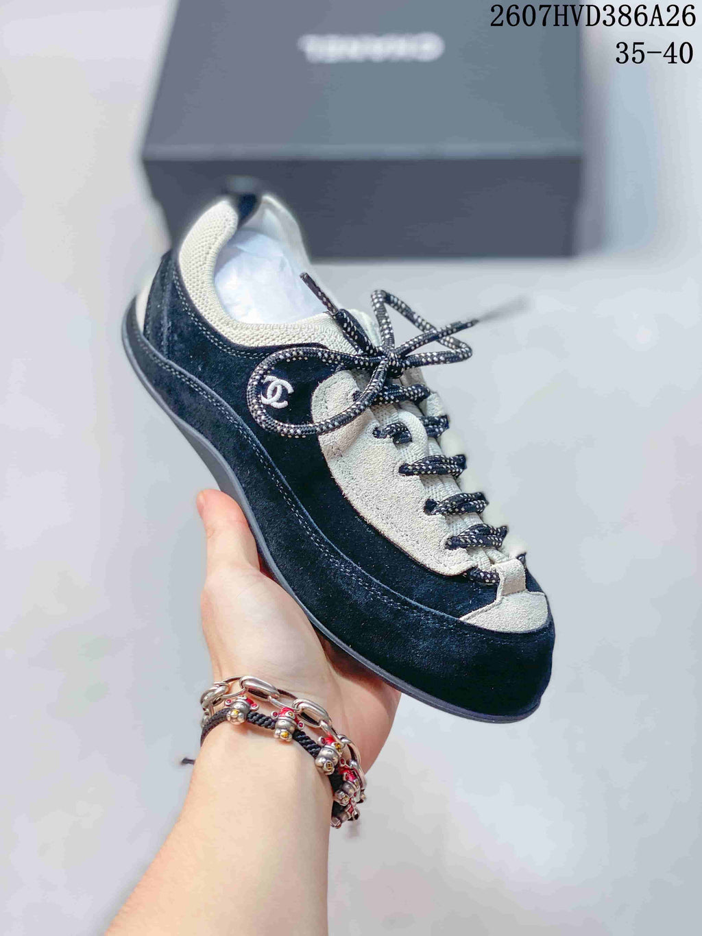 Angled side view of the black and white low-top sneaker with side branding and contrasting trim.