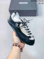 Angled side view of the black and white low-top sneaker with side branding and contrasting trim.