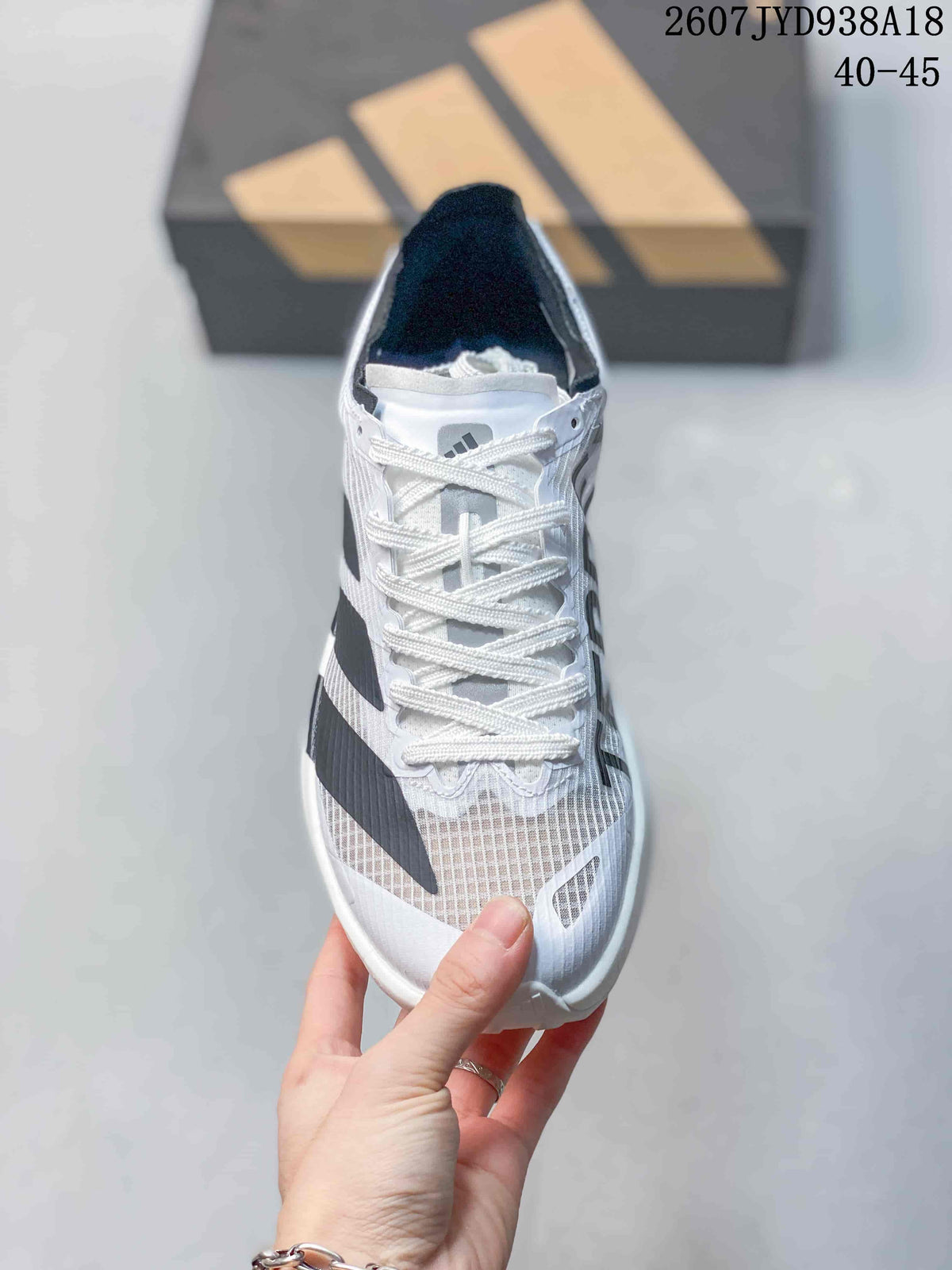Top view showing the white laces, tongue, mesh-style forefoot panels and black side stripes.