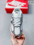 Top view of a white and grey Nike V5 RNR sneaker showing the mesh-like toe area, overlays, tongue, and laces.