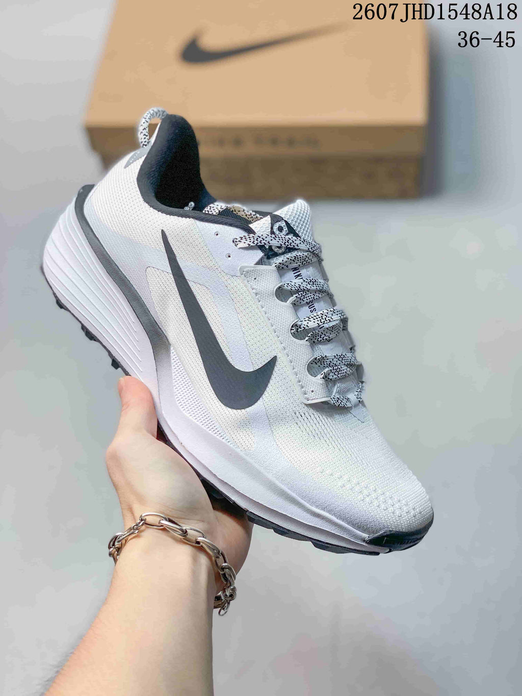 White Nike ReactX Pegasus ACG Trail 6 sneaker with black detailing and patterned laces.