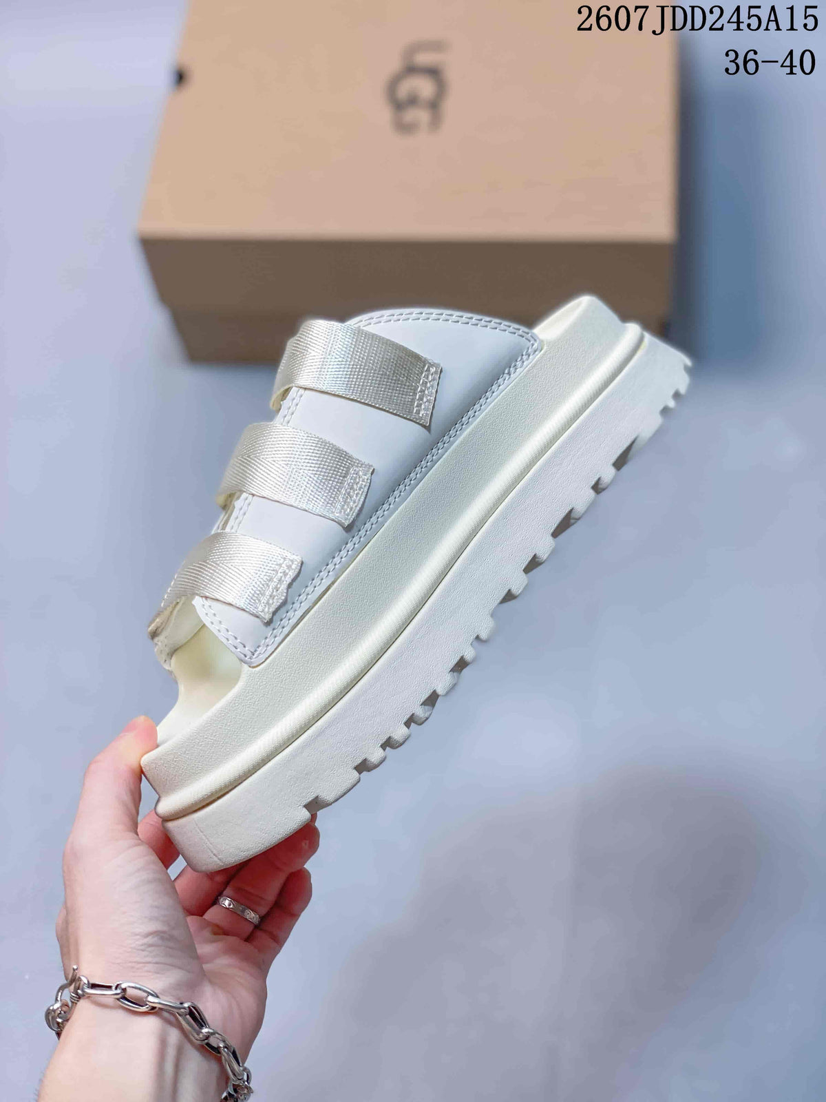 Side view of the white sandal showing the layered platform sole, three straps, and lugged outsole.