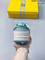 Rear view showing a white heel, gray panels, turquoise trim, and Nike tongue branding.