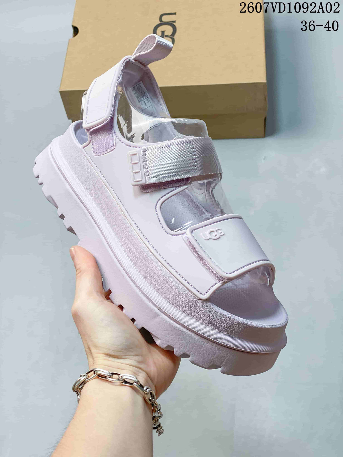 Side view of a pale lavender platform sandal with adjustable straps and a heel strap.