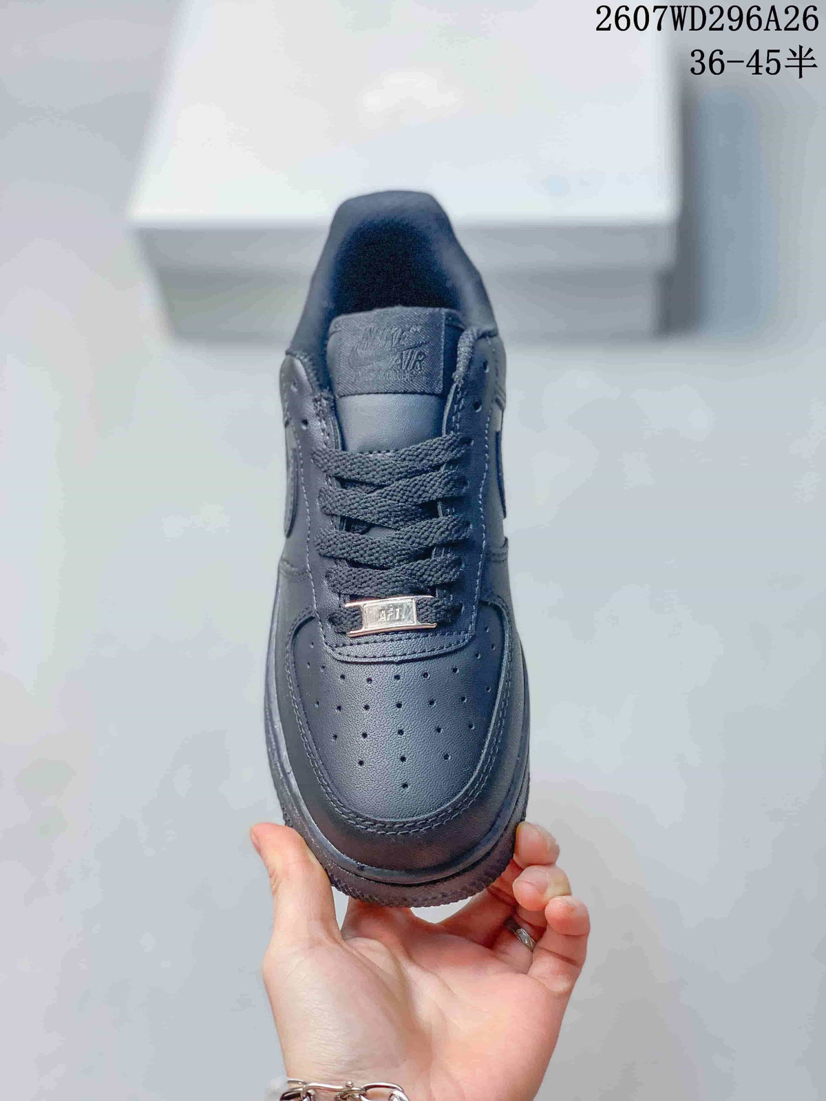 Top view of a black sneaker showing the perforated toe box, woven laces, tongue branding, and metal lace tag.