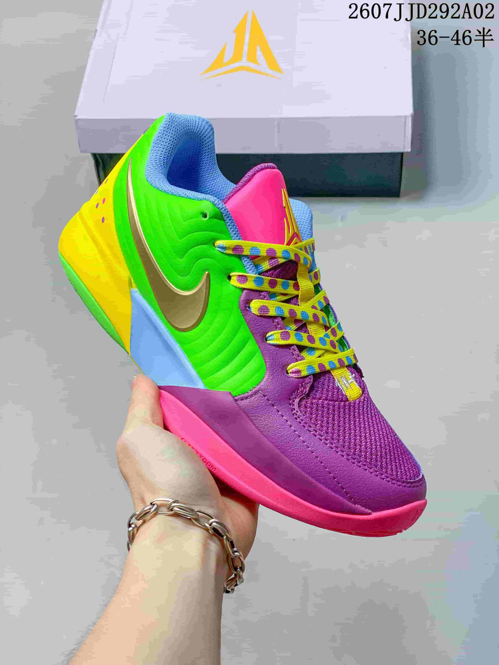 Angled side view of the multicolor basketball shoe showing the purple forefoot, green quarter panel, metallic swoosh and yellow heel.