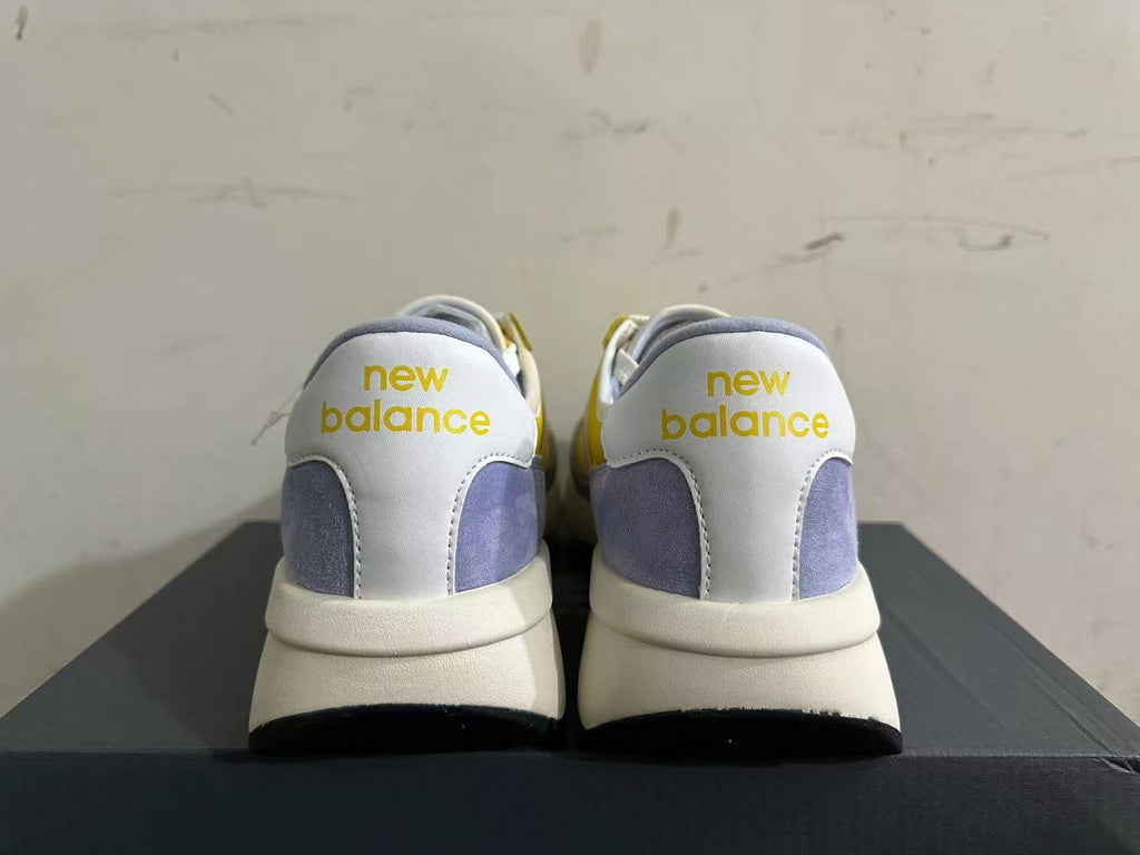 Rear view of yellow, white, and lavender New Balance U370 sneakers