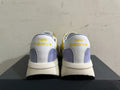 Rear view of yellow, white, and lavender New Balance U370 sneakers