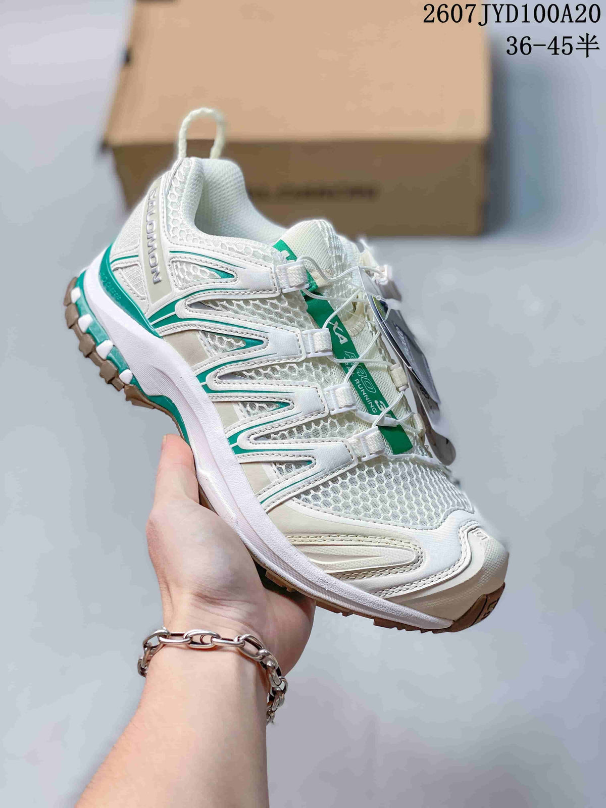White Salomon XA PRO 3D trail shoe with green accents and a contrasting brown outsole section.