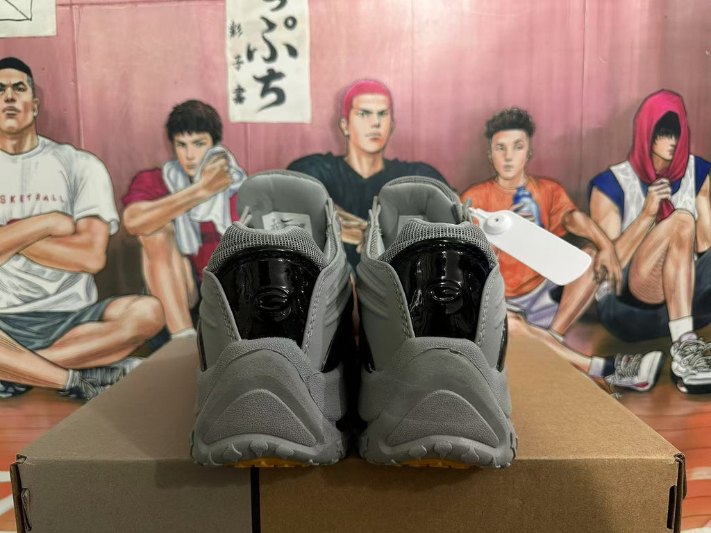 Rear view of grey sneakers with glossy black heel panels