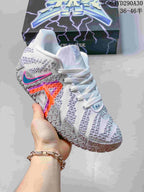 Angled side view highlighting the blue and pink accents and textured upper.