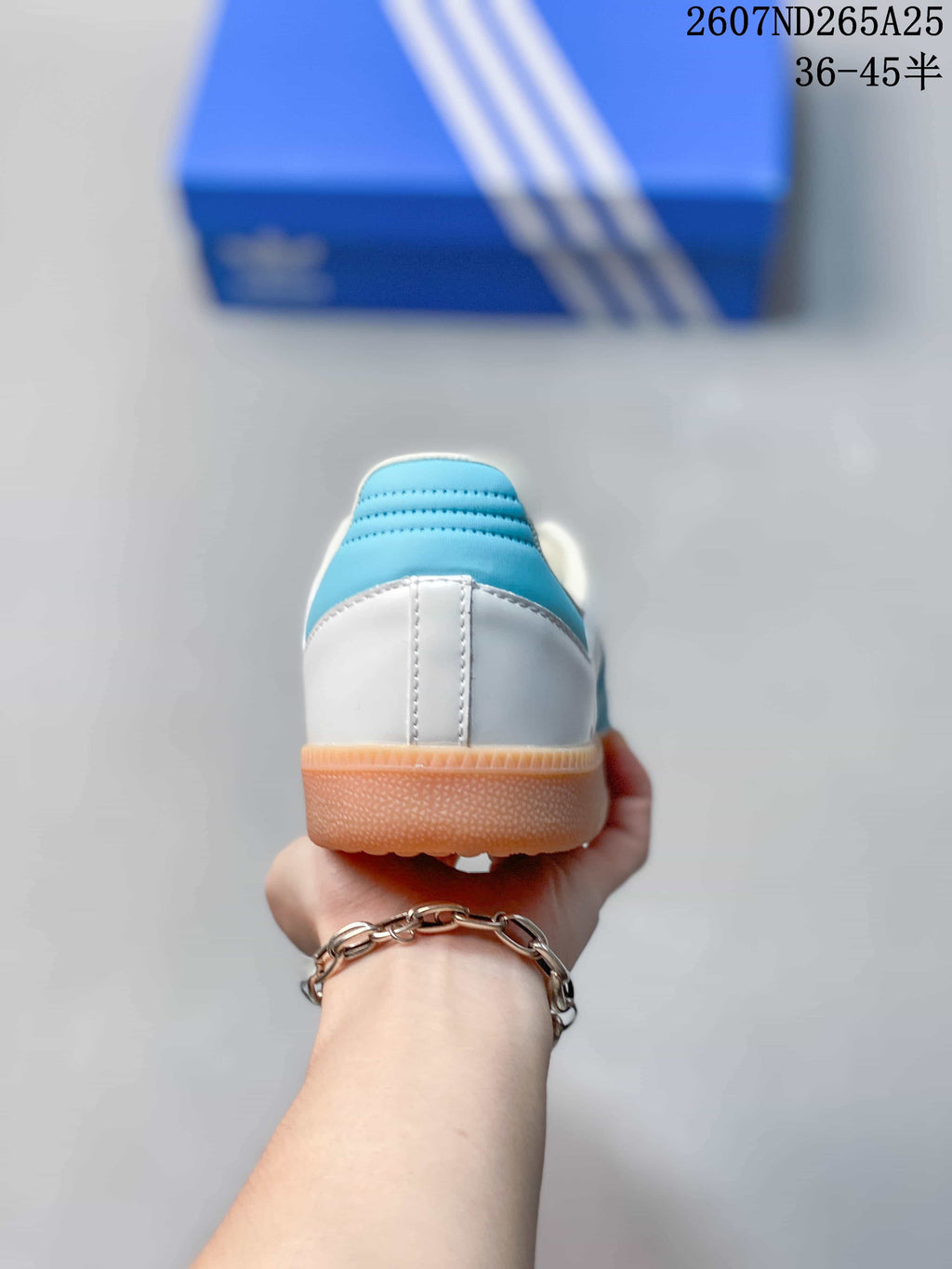 Rear view showing the white heel, blue heel collar detail, and gum outsole.