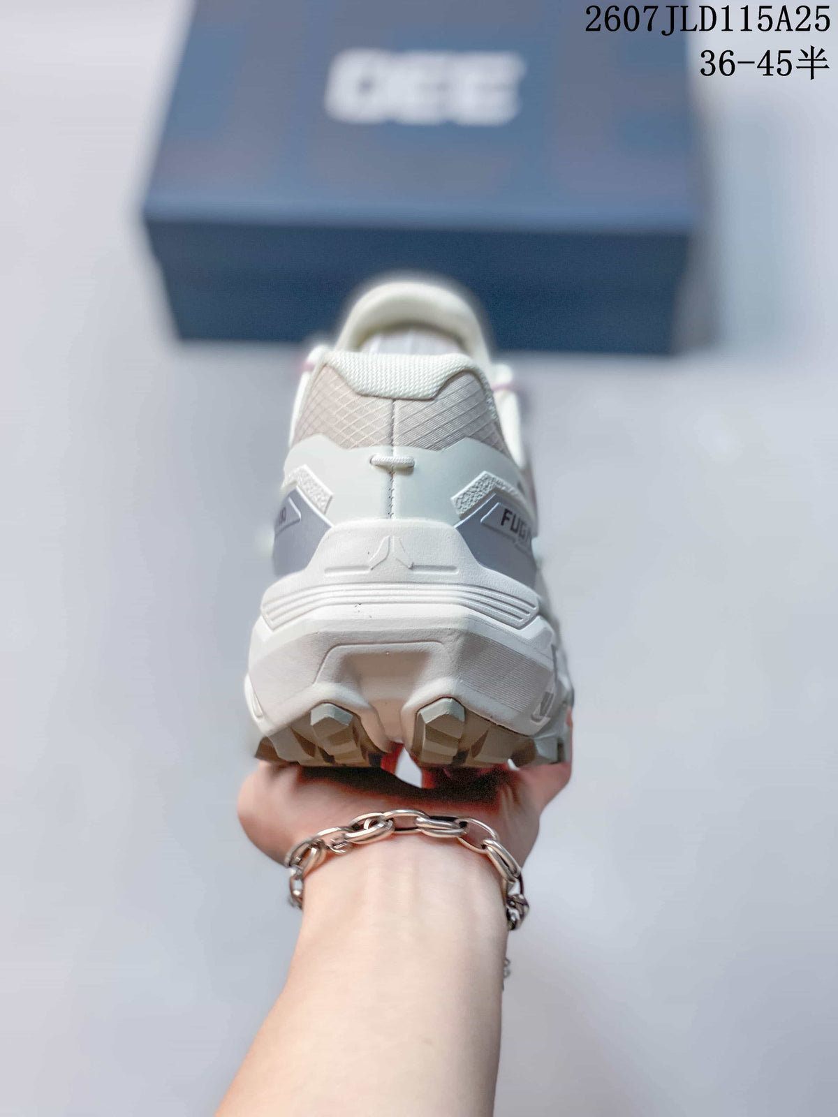 Rear view of the white trail running shoe showing the padded heel, layered sole, and outsole lugs.
