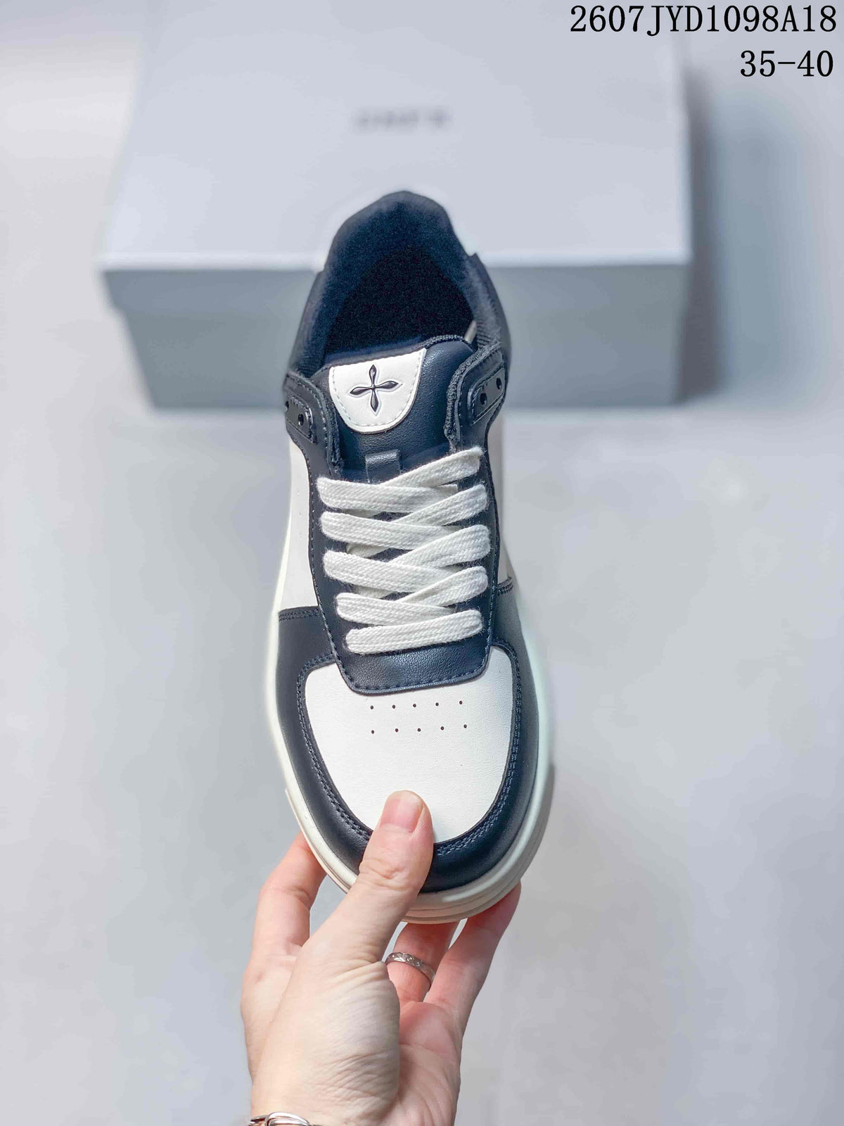 Top view showing the white laces, perforated toe panel and tongue emblem