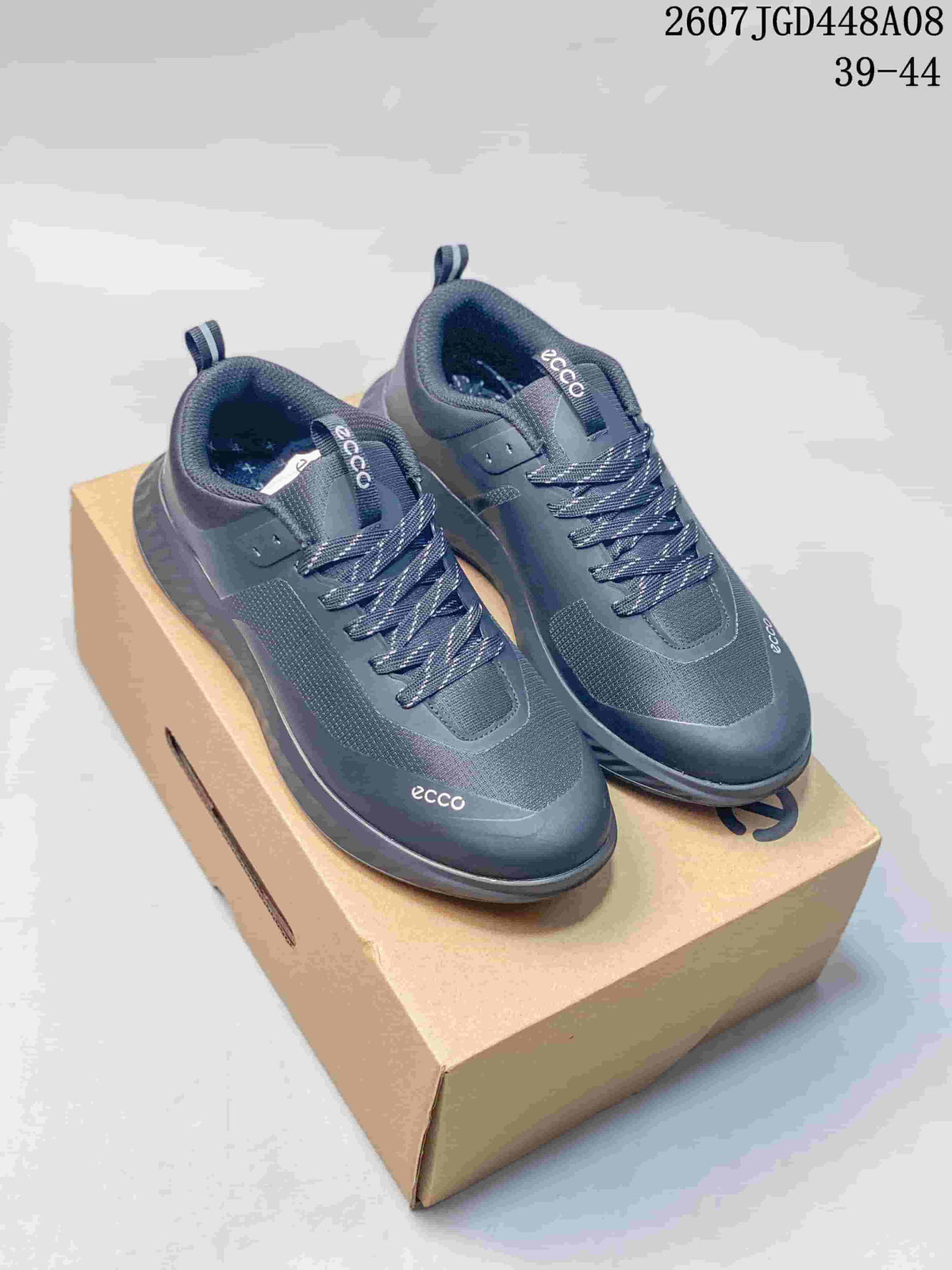 Pair of dark gray ECCO sneakers displayed on a branded shoe box