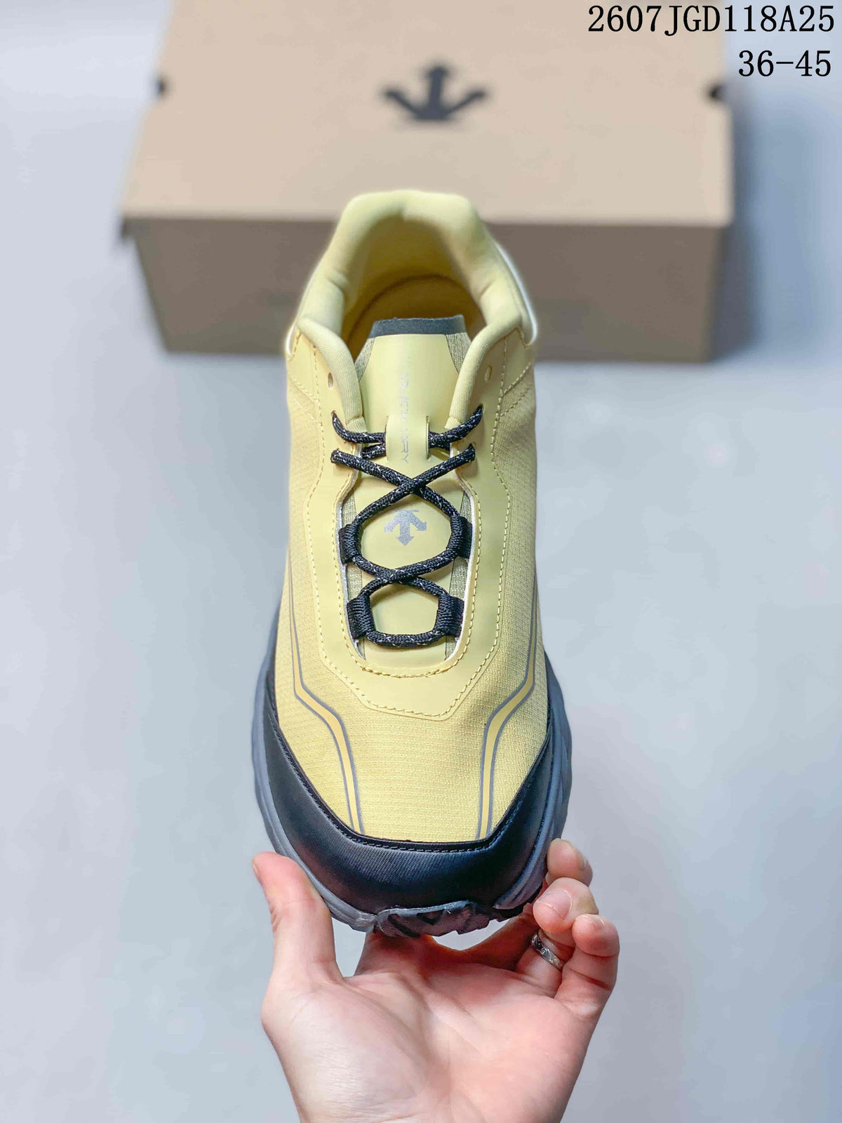 Top view of the sneaker showing black laces, yellow upper, and reinforced toe area.