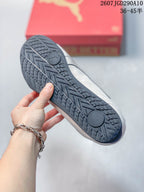 Close view of the dark rubber outsole showing its patterned tread and Puma logo.