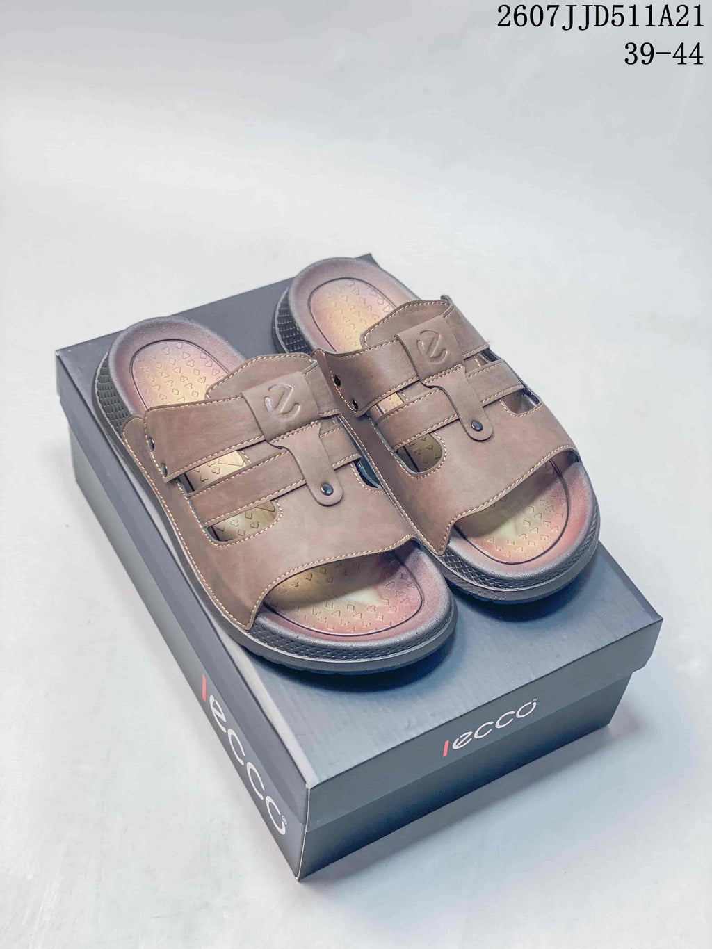 Brown ECCO open-toe sandals displayed on an ECCO shoe box; style code 2607JJD511A21 and size range 39–44 are visible.