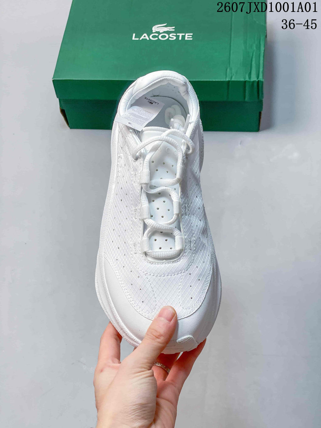 Top view of a white lace-up sneaker with perforated panels