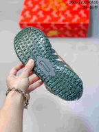 Close-up of the green textured outsole with repeating geometric tread.