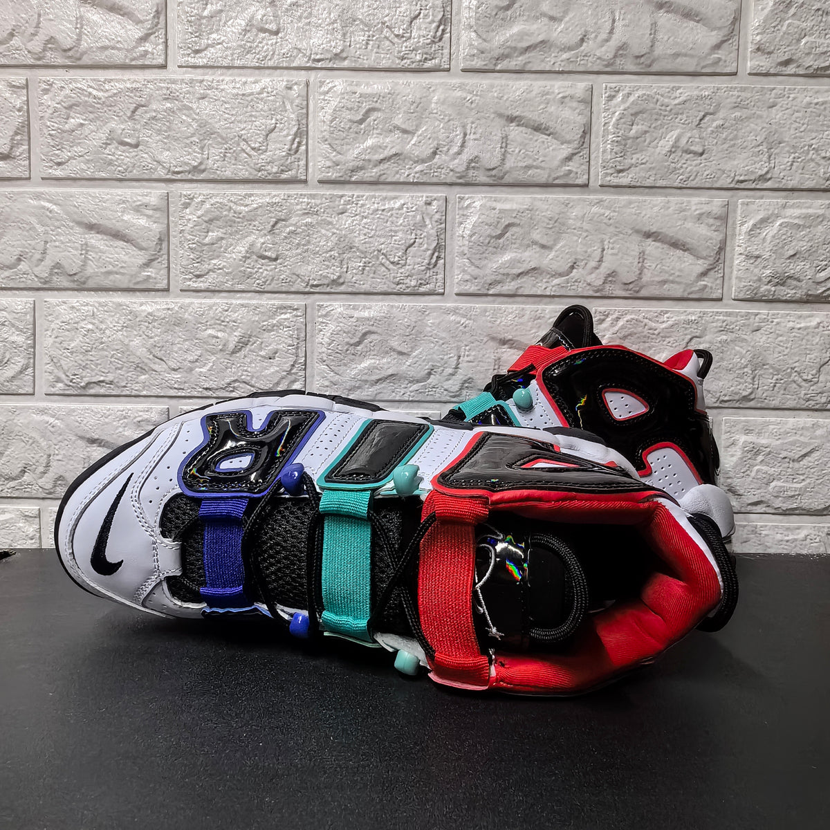 Top view highlighting the black tongue and red, aqua, and blue straps