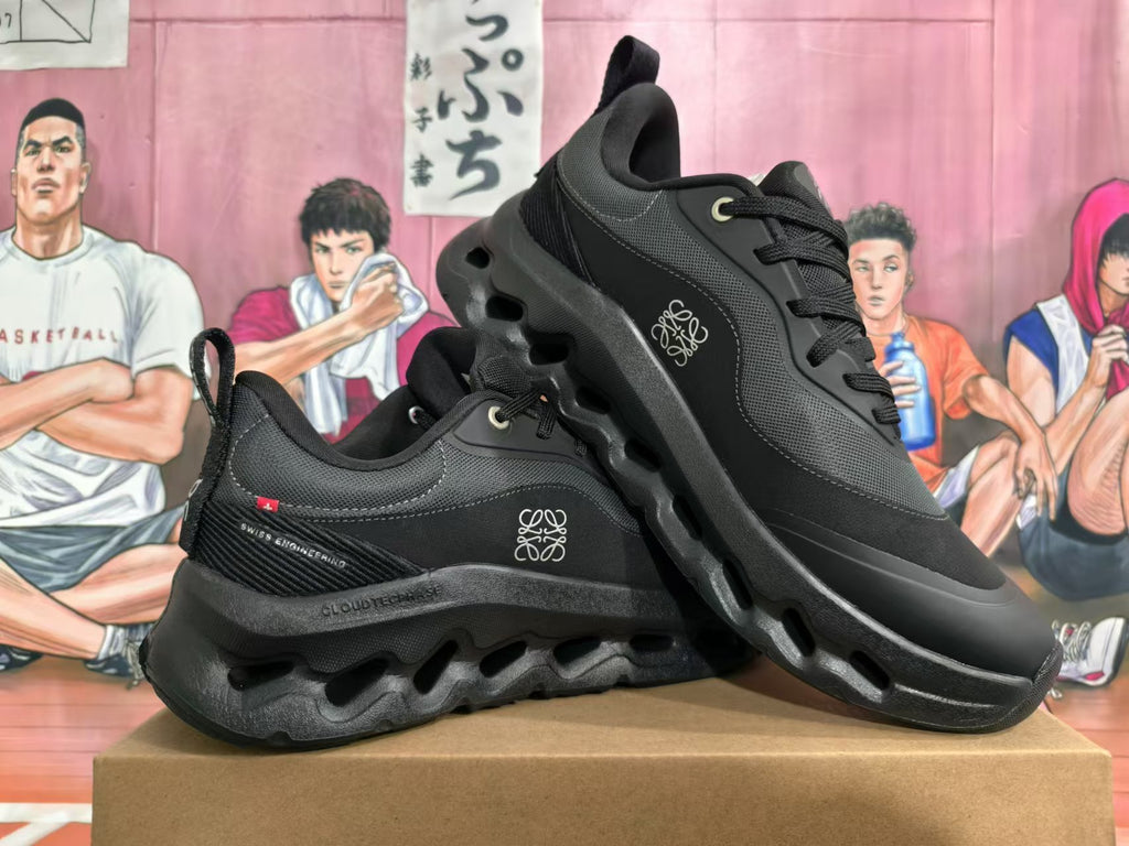 Pair of black On Cloudtilt sneakers shown from the side