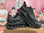 Pair of black On Cloudtilt sneakers shown from the side
