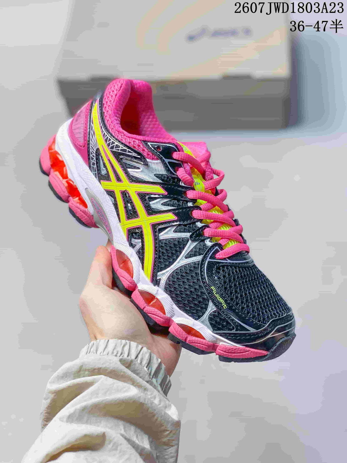 Black, pink and neon yellow ASICS Gel-Nimbus 16 sneaker with a contrasting sole.