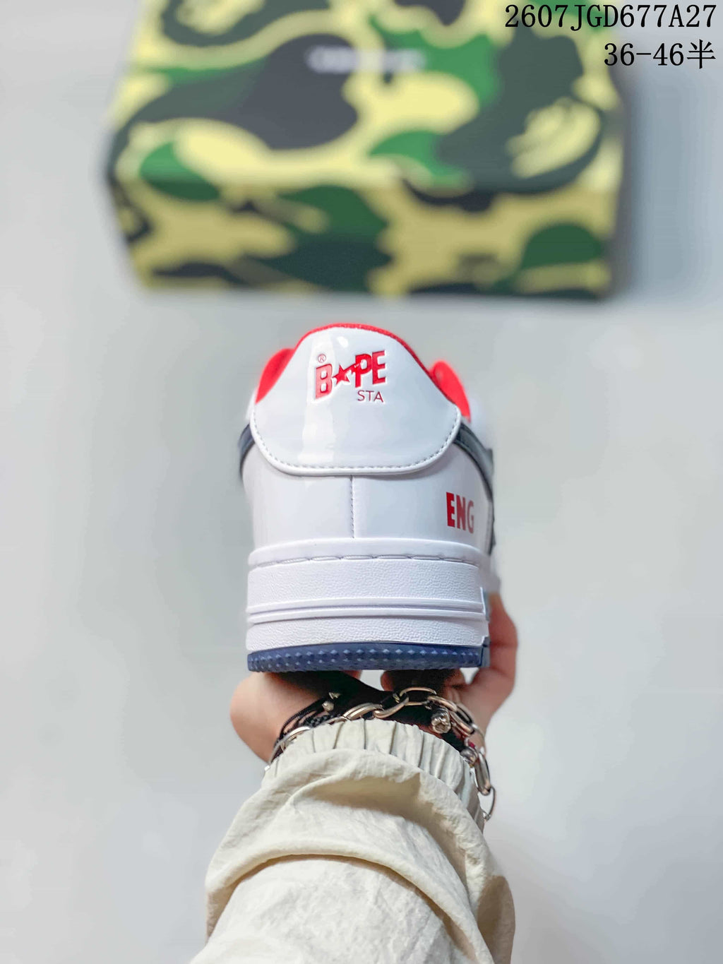 Rear view of a white BAPE Sta sneaker showing the red collar lining, branded heel tab and blue outsole edge.