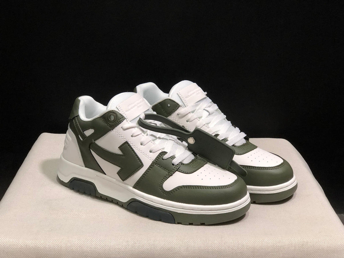 Three-quarter front view highlighting the white upper, olive overlays, laces, and detachable hangtag.