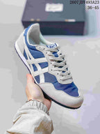 Close side view of a blue and white Onitsuka Tiger Serrano sneaker.