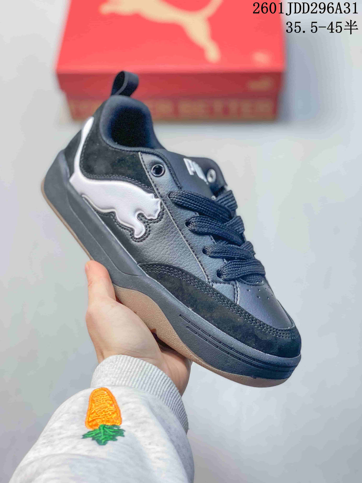 Side view of a black PUMA 180 sneaker with a white side detail and chunky sole.