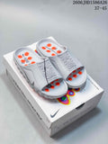 Pair of white Nike Mind slide sandals with orange details on a Nike Mind box