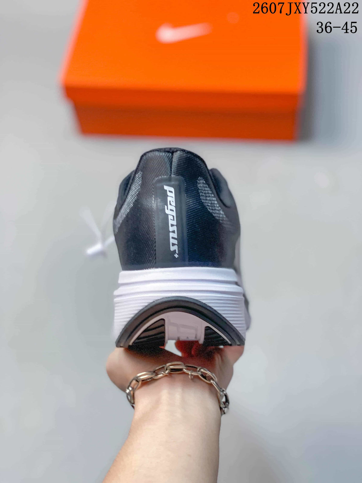 Rear view of a Nike running shoe showing the dark heel, white midsole, and outsole tread