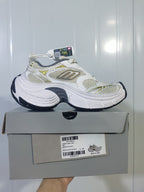 Skechers sneaker displayed on its box, showing the side profile, color combination, and product label.