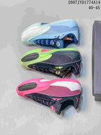 Top-down view showing blue, pale green, neon green, and pink colorway examples of the Jordan Triangle basketball shoe.