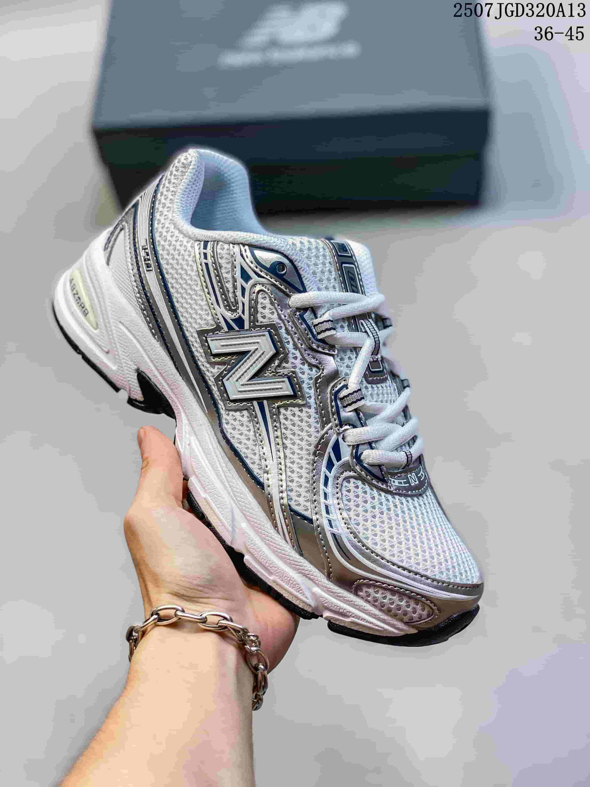 Angled side view showing the white, silver, and navy upper with the New Balance logo.