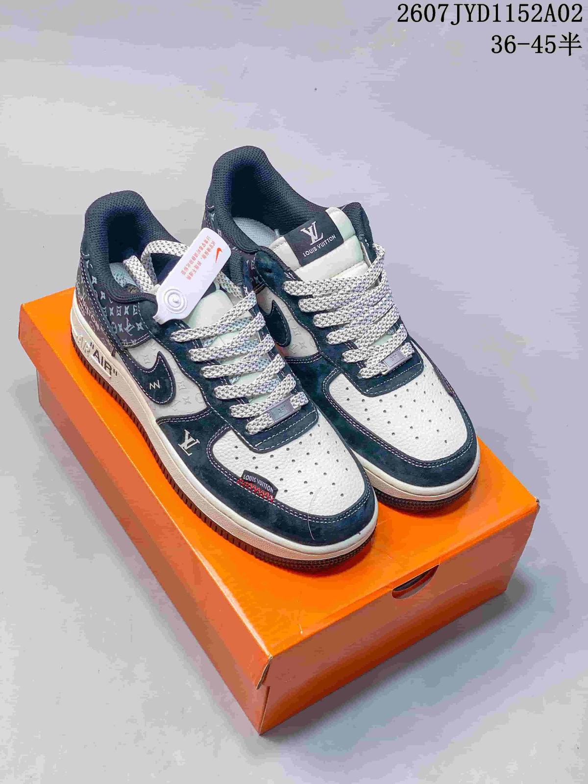 Pair of navy-and-white low-top sneakers with patterned overlays and laces