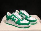 Three-quarter view of the white and green pair showing the star side graphics, white midsoles, and green outsoles.