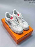 Off-white low-top sneakers with gray accents and red tongue labels, shown on an orange box