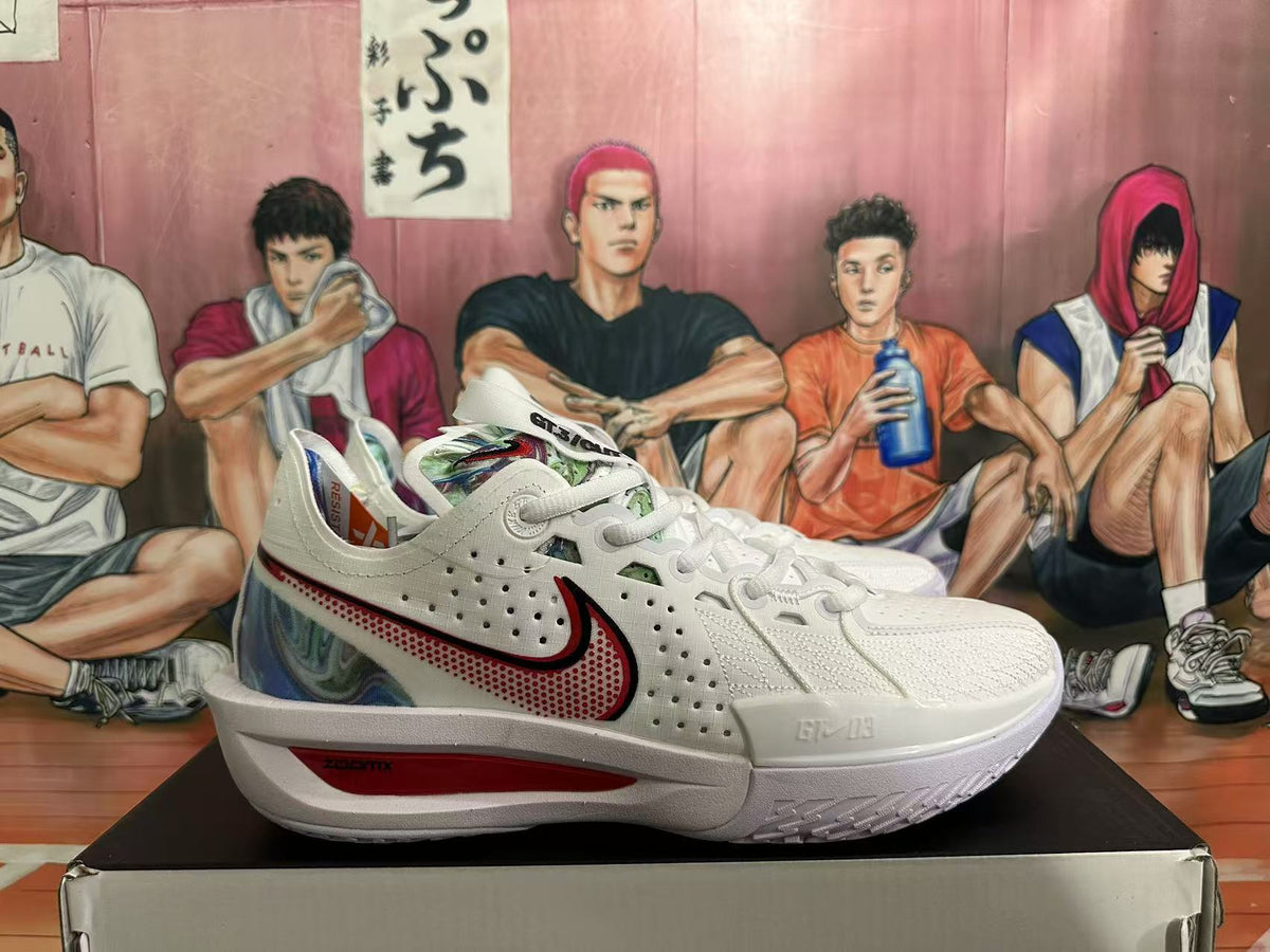 Side view of a white Nike basketball sneaker showing the perforated upper, red-accented Swoosh, multicolor heel panel and red midsole insert.