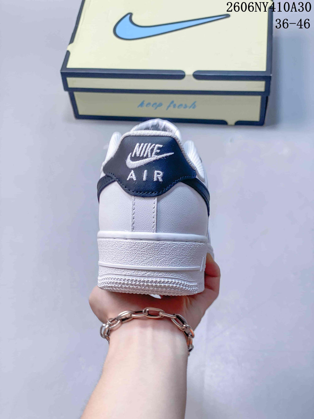 Rear view of the sneaker with a navy heel tab and white midsole