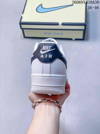 Rear view of the sneaker with a navy heel tab and white midsole