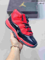 Close-up side view of a black and red high-top sneaker with red laces, red panels and a translucent-looking outsole.
