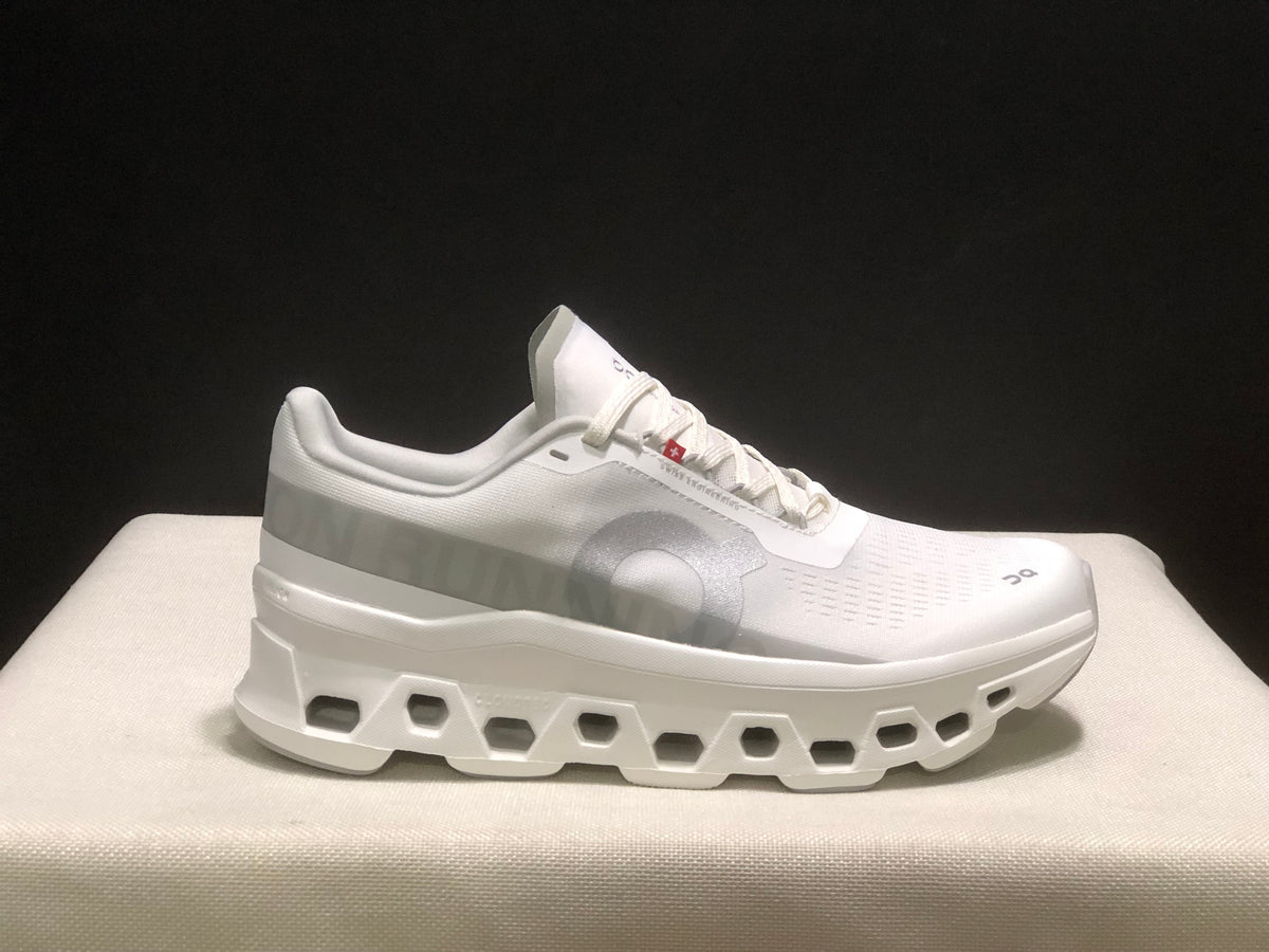 Close side view highlighting the tonal side branding and geometric sole openings.