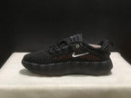 Side profile of a black sneaker showing its thick sculpted black outsole and perforated upper.