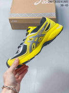 Side view of the yellow sneaker with silver overlays and charcoal mesh-look panels.