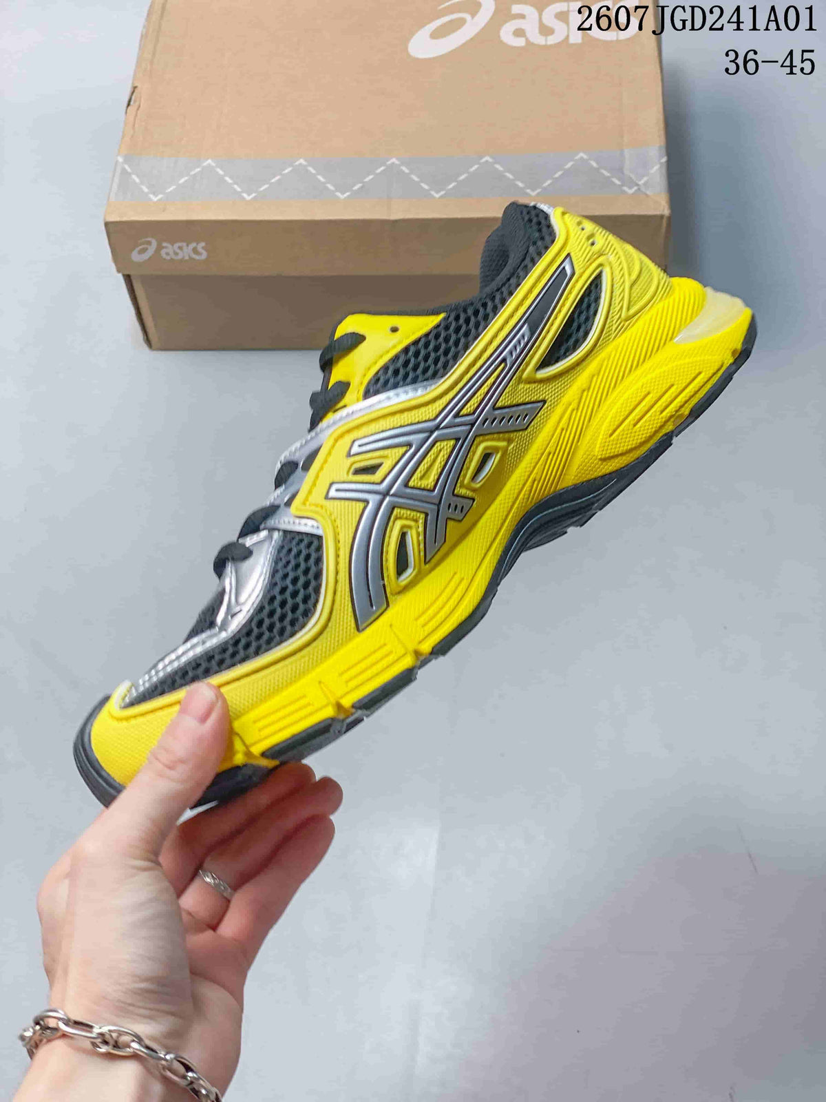Side view of the yellow sneaker with silver overlays and charcoal mesh-look panels.