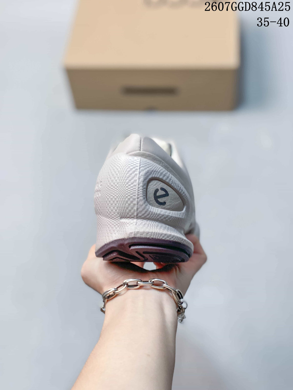 Rear view of the white sneaker showing the heel counter, ECCO-style logo detail, and outsole edge.